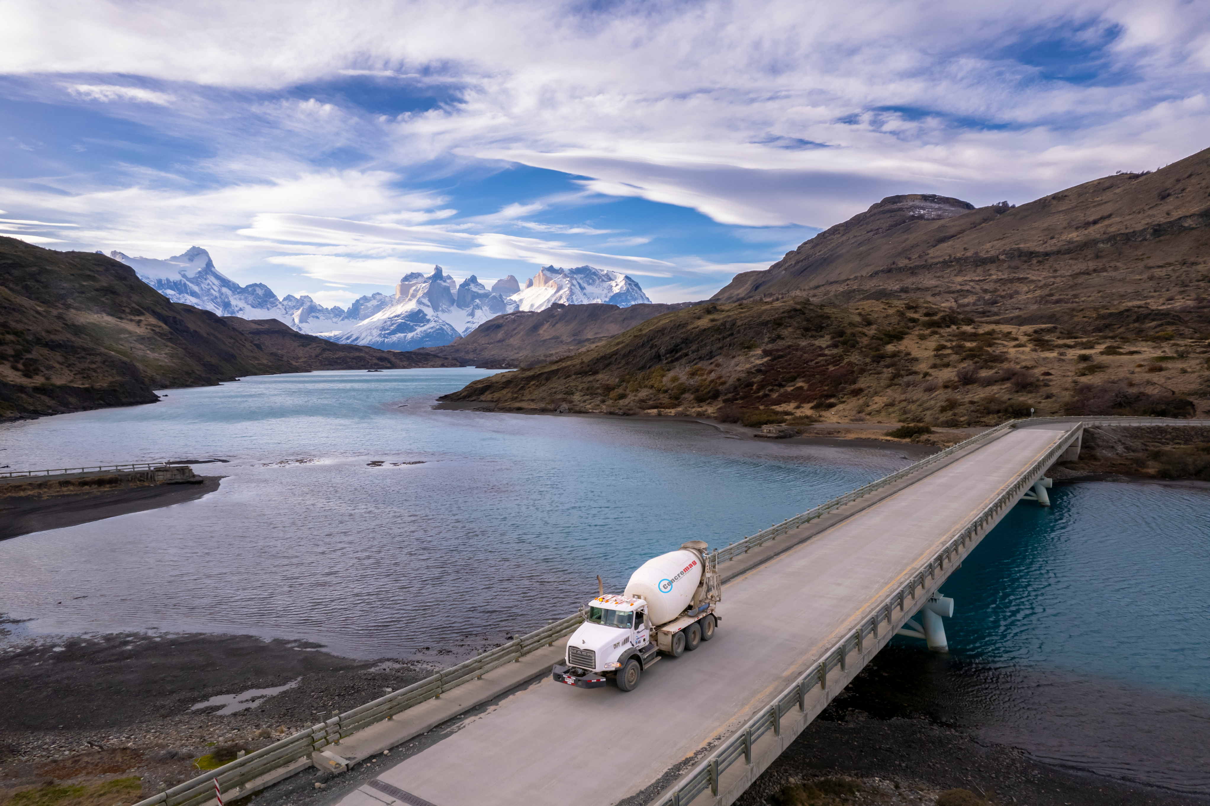 Concremag mixer truck crossing bridge in Patagonian landscape